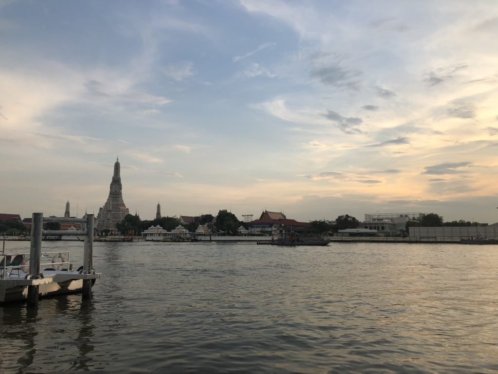 Wat Arun, seen across the Chao Phraya River as the sun sets
