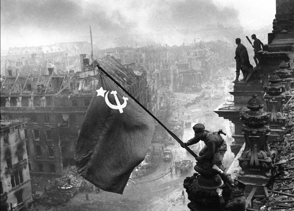 Famous picture of Soviets raising the union flag over the Reichstag. Vasily Grossman saw this sight following the events of Life and Fate.